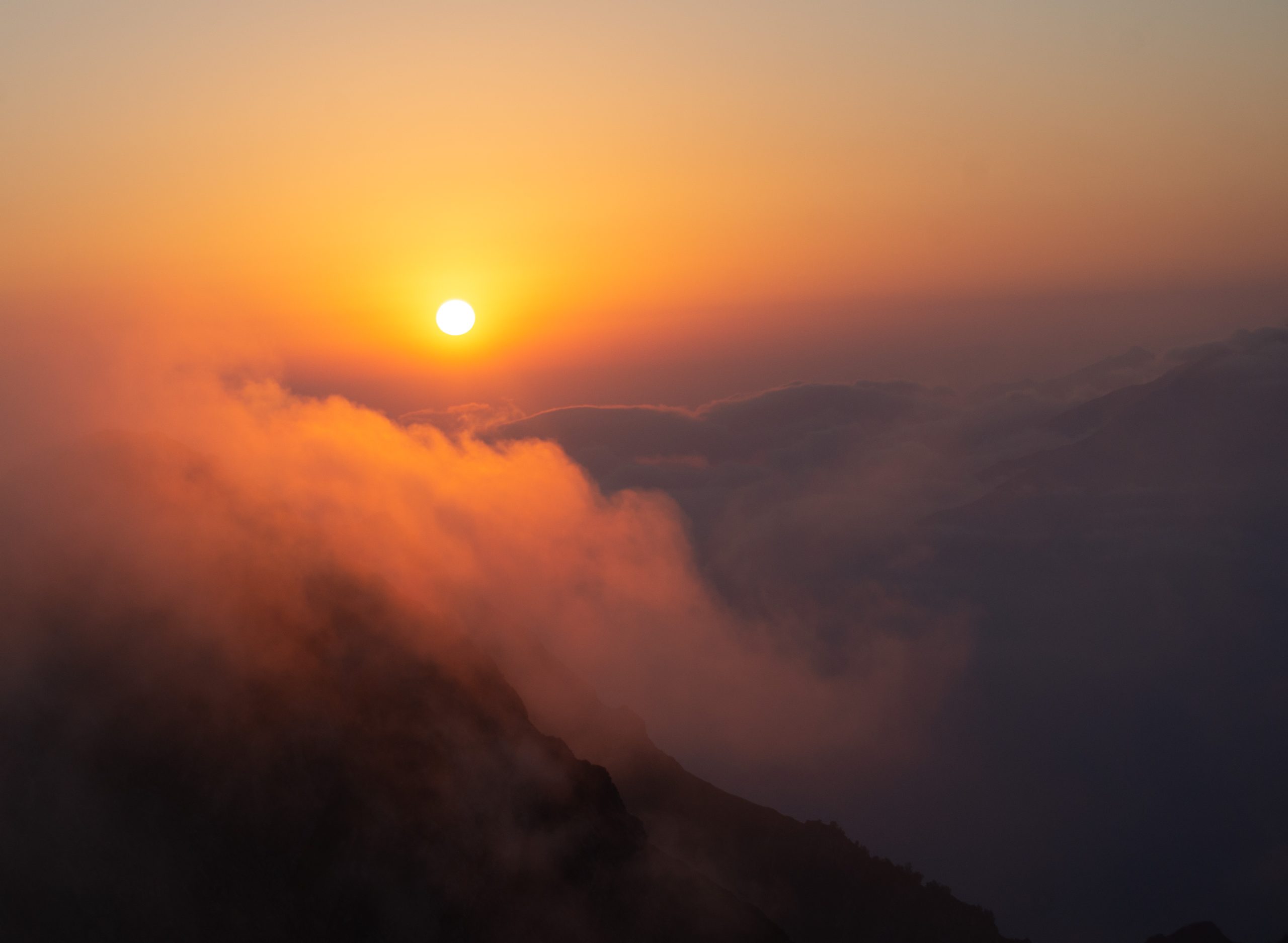 Sunrise over a mountain peak, symbolising new beginnings, quiet strength, and emphatic humility.